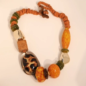 Detail of bohemian necklace with leopard print beads and turquoise resin elements