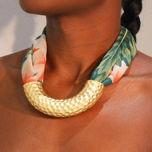 Hammered gold U-shape necklace with floral silk scarf straps on female neck