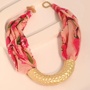 Detail of pink floral silk scarf necklace with golden U-shaped hammered metal pendant