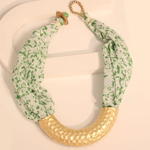 Detail of green heart print chiffon and golden hammered metal on a U-shaped necklace