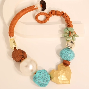 Bohemian woven rope necklace with turquoise beads and hammered gold heart pendant
