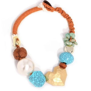 Bohemian beaded heart necklace with turquoise accents and pearls on orange rope