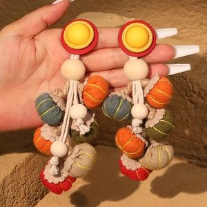 Handmade bohemian pumpkin tassel earrings with colorful fabric balls and wood beads
