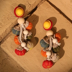 Handmade fabric pumpkin tassel earrings for women with colorful beaded design on stone