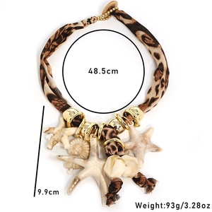 Detail view of Bohemian choker featuring leopard print fabric, starfish, and shell charms