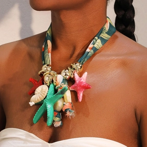 Bohemian tropical print choker with starfish shells and gold rings on model