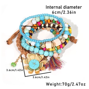Detail view of multi-layered beaded bracelets with turquoise stones and floral pendants