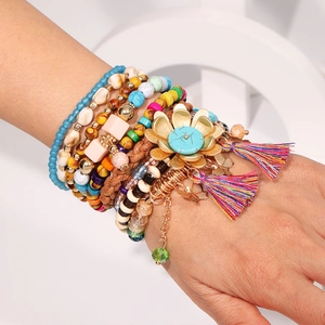 Bohemian multilayer beaded bracelet set with floral charms and colorful tassels on wrist
