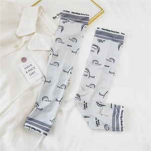 Detail of grey sun protection sleeves with cartoon print and thumb hole for summer