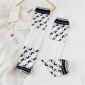 Detail of white cooling arm sleeves with wave pattern and embroidered wrist cuff