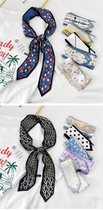 Vue détaillée de foulards étroits en soie à motifs noués au cou avec des imprimés de fraises