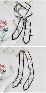 Détail du foulard twilly en soie crème avec lignes géométriques et bordure noire