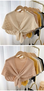 Close-up of hollowed-out knit shawls with tie-front detail in multiple colors
