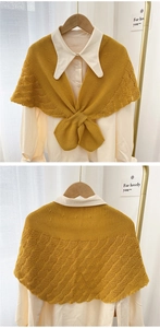 Close-up of ginger yellow knitted shawl with wavy texture and front bow tie detail