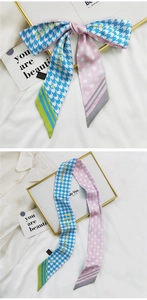 Détail d'une écharpe en polyester bleu et rose avec motifs pied-de-poule et pois fins