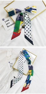 Détail d'un foulard en soie imprimé avec motifs de cœur et nautiques pour cheveux et sacs