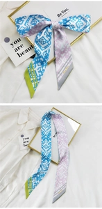 Détail d'un ruban à cheveux en soie style français avec motif géométrique bleu et rose