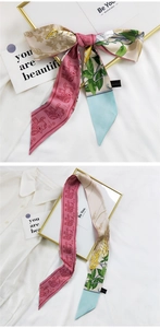 Détail d'un foulard en soie avec imprimé éléphant rose et motifs floraux sur chemise