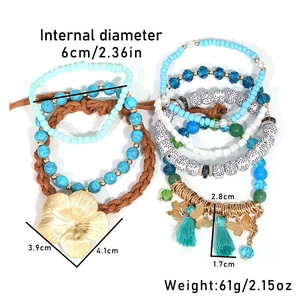 Detailed view of bohemian blue beaded bracelets with tassel and flower pendants