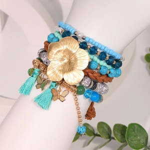 7-piece Bohemian stackable bracelet set with blue beads, tassels and butterfly charms