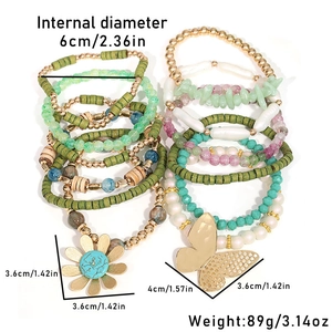 Detail view of colorful bohemian beaded bracelets with sunflower and butterfly charms