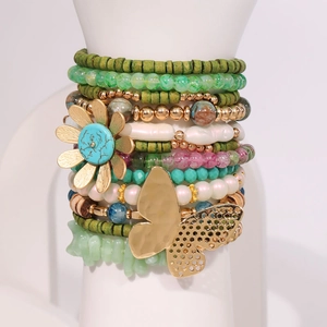 Bohemian multi-layer bracelet set with butterfly and sunflower charms on a display model