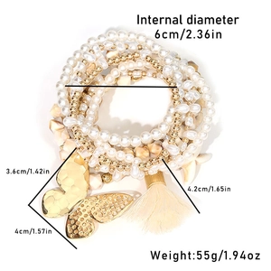Detail of bohemian layered beaded bracelet set with starfish charm and butterfly pendant