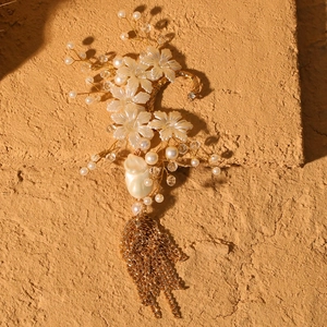 Exquisite bridal ear cuff with white flowers, pearls, and long gold chain tassels