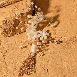 Elegant floral bridal ear cuff with faux pearls, crystals and long gold chain tassels