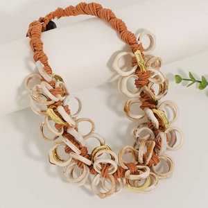 Bohemian orange woven rope necklace with chunky white resin rings and gold metal accents