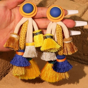 Bohemian oversized tassel earrings with colorful fringe and woven cord detailing
