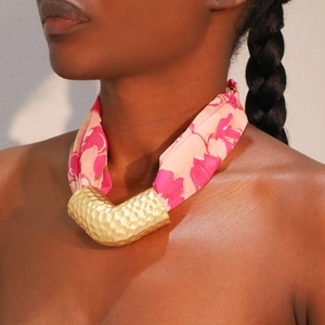 Bohemian floral fabric scarf necklace with a hammered gold V-shape pendant on a model