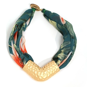 Bohemian tropical floral fabric necklace with a textured V-shaped gold metal pendant