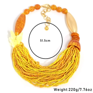 Detail of yellow multi-layer beaded necklace with orange accent beads and 51.5cm length