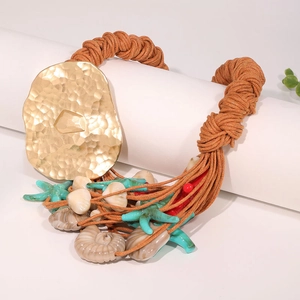 Bohemian beach starfish shell necklace with hammered gold metal and woven brown cord