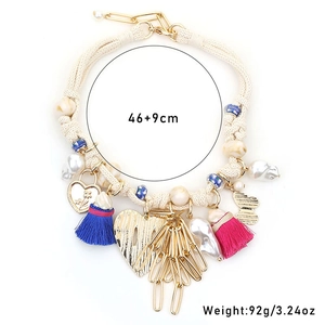 Detail of bohemian heart pendant necklace with colorful tassels and bead accents