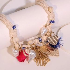Ethnic heart pendant necklace with pearls and colorful tassels on beige braided rope