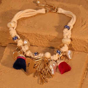 Bohemian tassel necklace with heart pendant, baroque pearls, and blue beads on stone