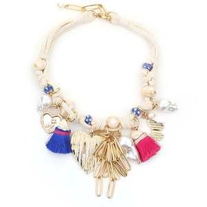 Bohemian woven cord necklace with gold heart charms, vibrant tassels, and pearl beads