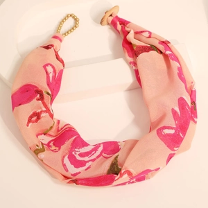 Detail of bohemian floral print fabric necklace with gold beads and wood button