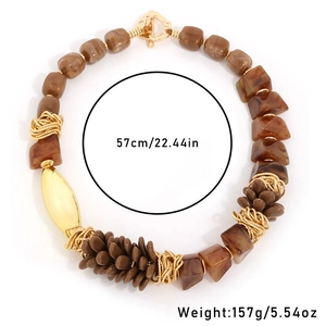 Ethnic style necklace with resin pinecone and amber beads on white background