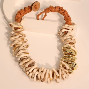 Handmade bohemian necklace with brown braided rope and marble resin rings on white blocks