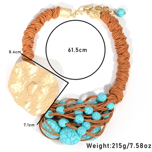 Bohemian turquoise beaded necklace with large gold hammered metal pendant and woven rope