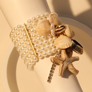Elegant multilayer pearl stretch bracelet with gold starfish and seashell charms