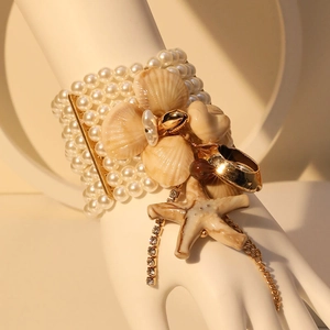 Elegant multi-layer pearl stretch bracelet with starfish, seashell charms and gold tassels
