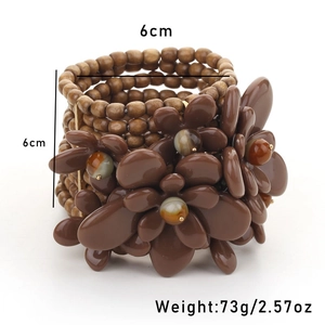 Macro detail of multi-layer wood bead bracelet with floral accents and 6cm dimensions