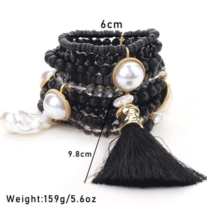 Detailed view of bohemian black beaded multi-layer bracelet with large silk tassel charm