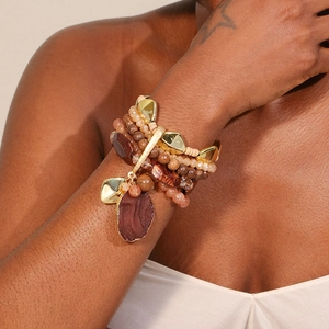 Detail view of multi-layer beaded bracelet featuring natural stone charms and gold accents