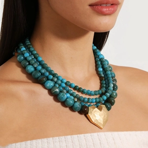 Multilayer beaded necklace with a golden hammered heart pendant for summer beach wear