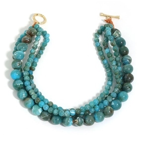 Detail of four-layer beaded necklace with blue marble patterns and golden toggle clasp